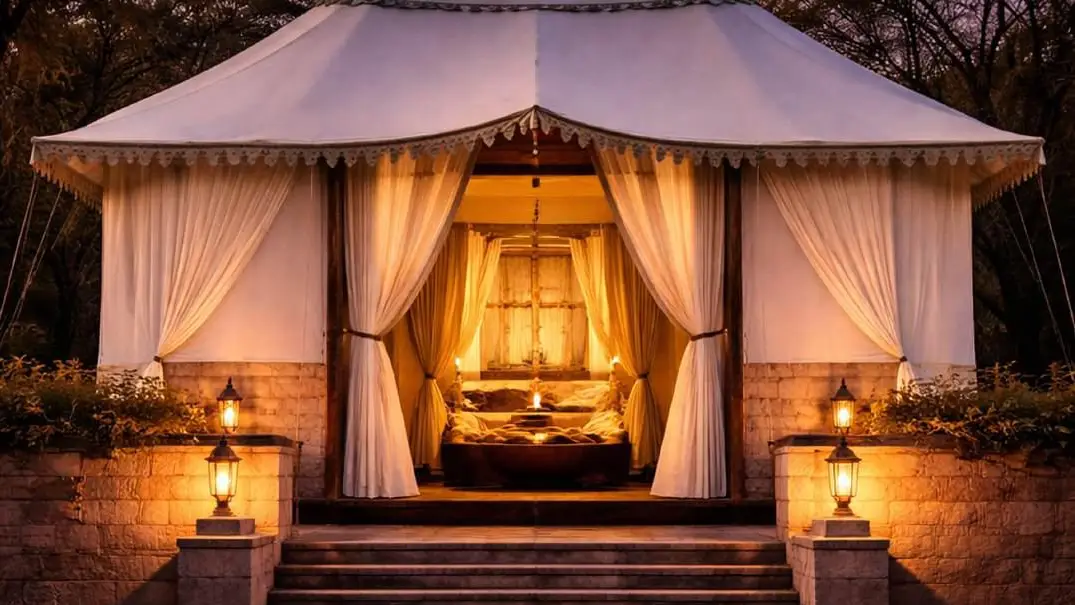 Sawai Villas canopy tent interior in Ranthambore with white drapes, warm lanterns and luxury bedding